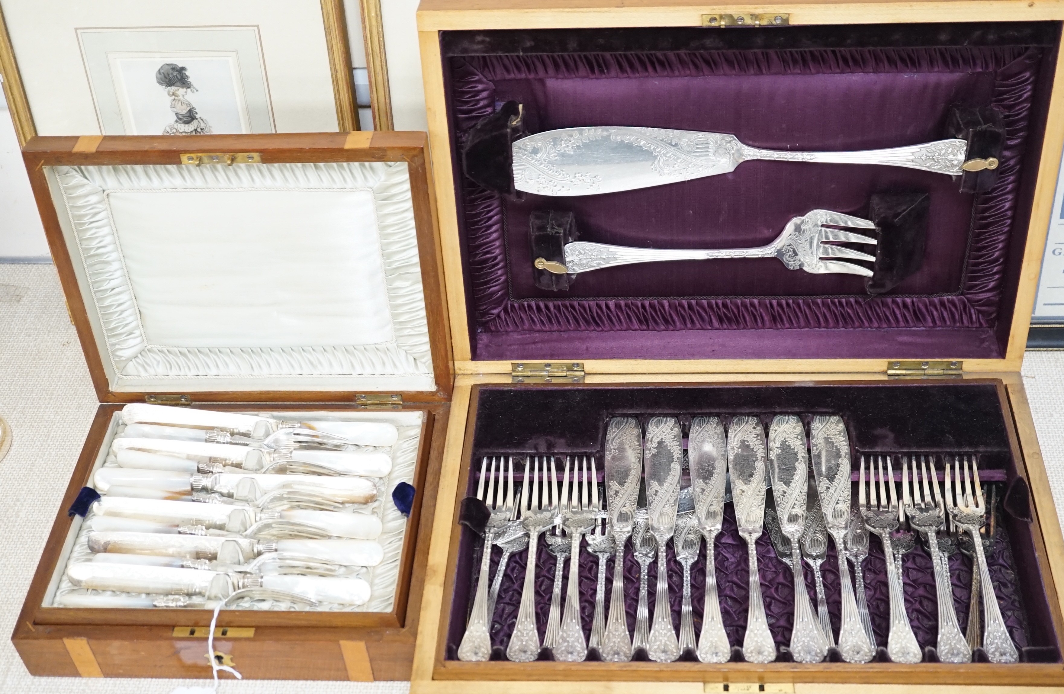Two cased electroplate sets: a set of twelve fruit eaters and twelve fish knives and forks